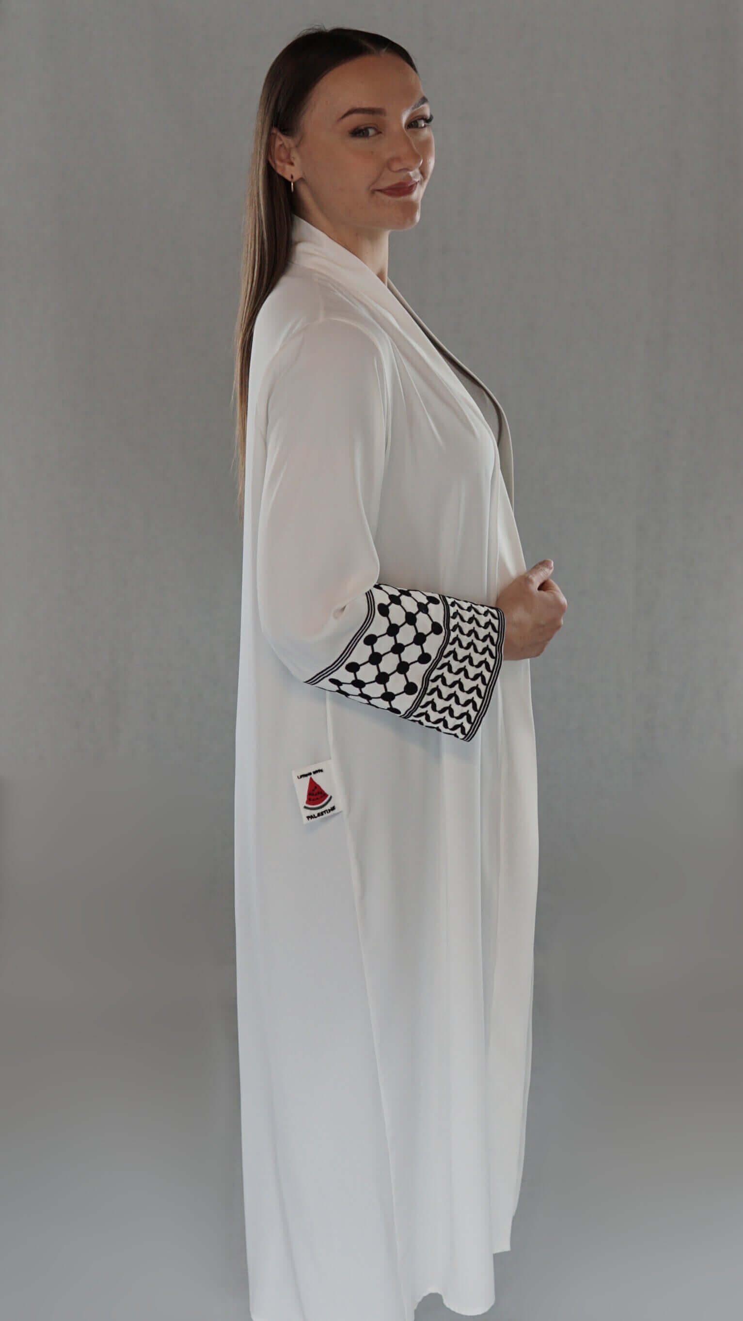 Elegante weiße Abaya mit traditionellem palästinensischem Design und Olivenblattmuster an den Ärmeln.