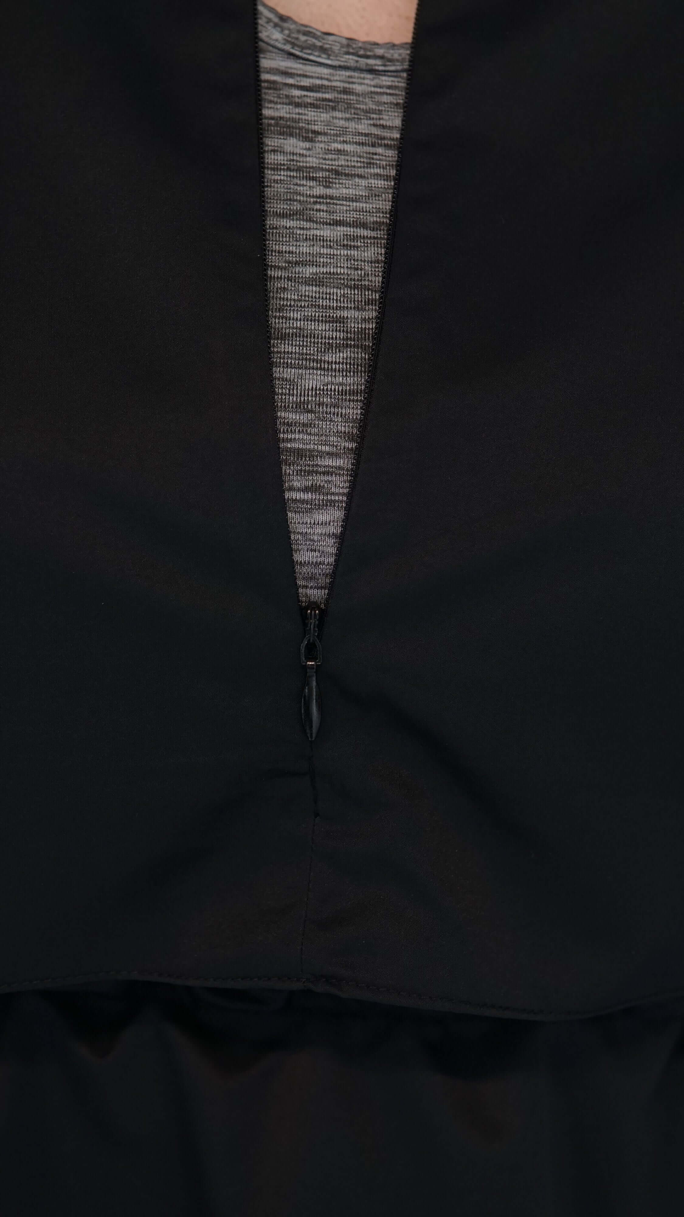 Black bathing tunic with zipper detail showcasing modern design and comfort for optimal swimming performance.